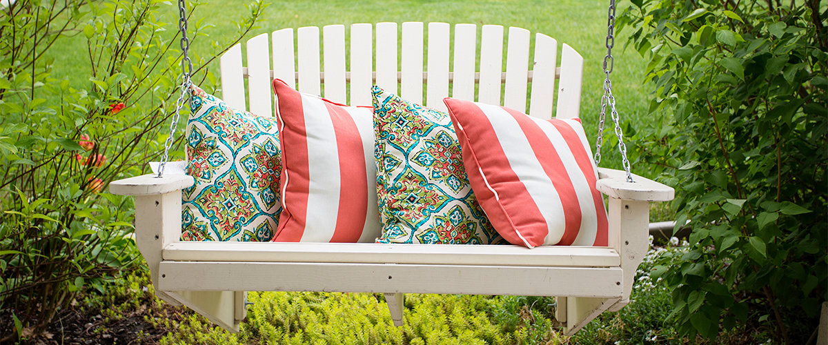Porch swing with decorative pillows